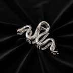 Silver serpent clip on black velvet